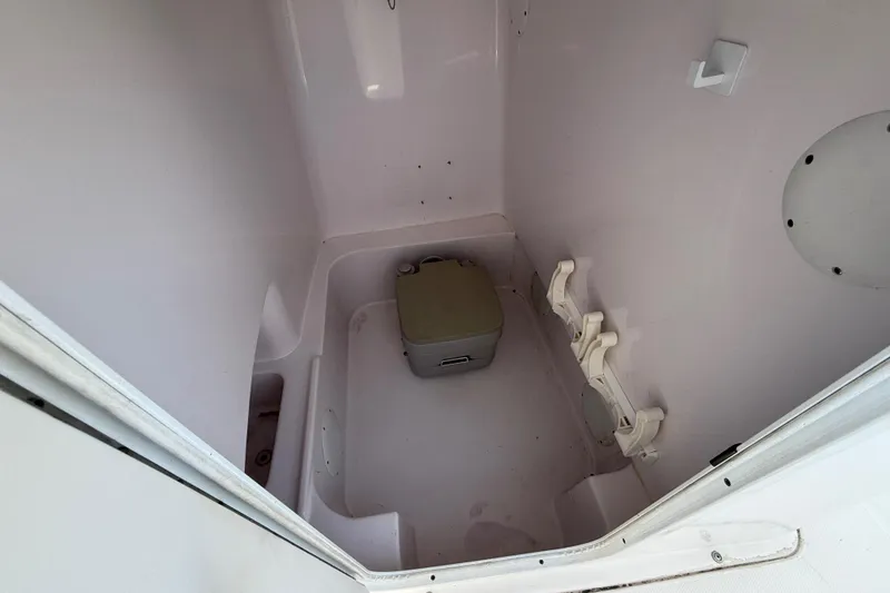 Slide: The Image of 2016 Pro-Line 35 Super Sport boat interior with compact toilet setup. - 19