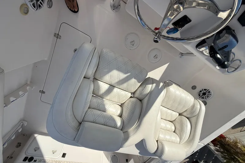 Slide: The Image of 2016 Pro-Line 35 Super Sport boat interior with white leather seating and steering wheel. - 21