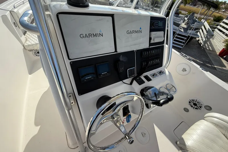 Slide: The Image of 2016 Pro-Line 35 Super Sport boat dashboard with Garmin navigation system and controls. - 22