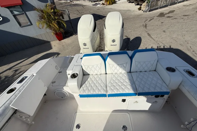 Slide: The Image of 2016 Pro-Line 35 Super Sport boat with dual Suzuki 300 engines and cushioned seating. - 25