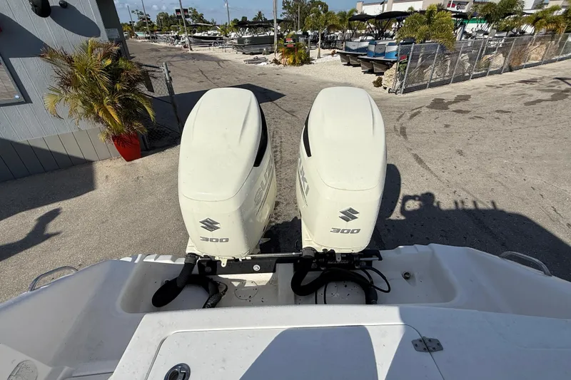 Slide: The Image of 2016 Pro-Line 35 Super Sport with twin Suzuki 300 outboard engines at a marina. - 37