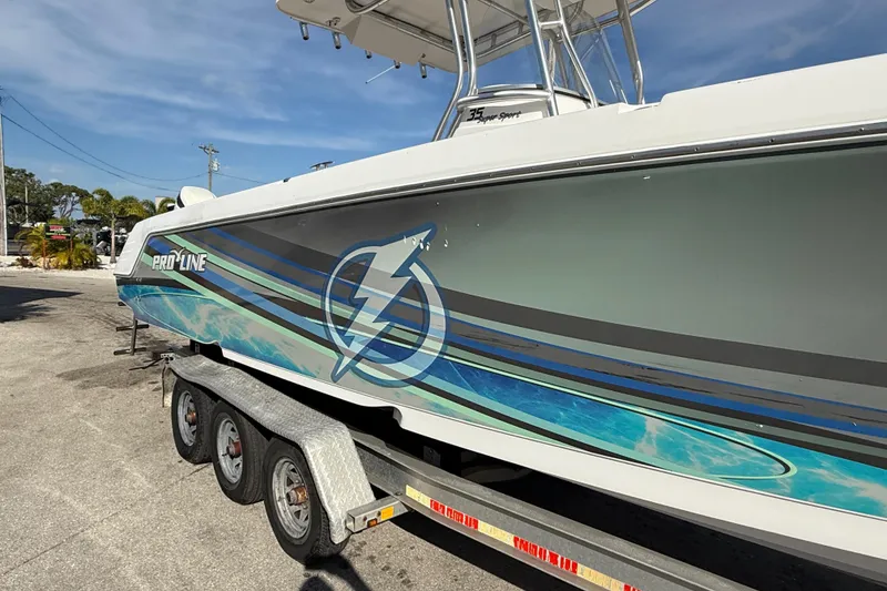Slide: The Image of 2016 Pro-Line 35 Super Sport boat on trailer, featuring dynamic blue and gray graphics. - 6