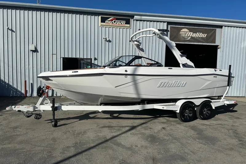 The Image of 2026 Malibu Wakesetter 23 LSV boat on trailer outside Malibu Boats facility. - 1