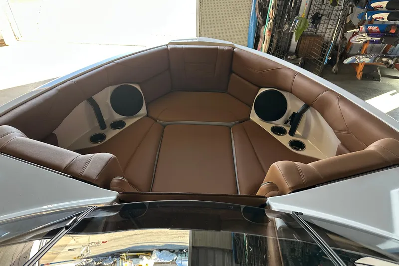 Slide: The Image of 2026 Malibu Wakesetter 23 LSV boat interior with brown leather seating and built-in speakers. - 10