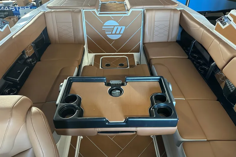 Slide: The Image of 2026 Malibu Wakesetter 23 LSV interior with brown leather seating and cup holders. - 12