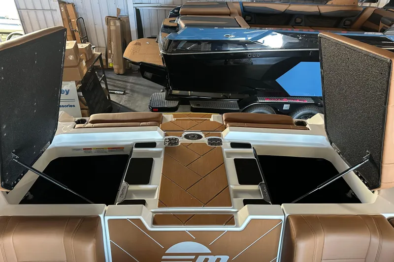 Slide: The Image of 2026 Malibu Wakesetter 23 LSV boat interior with open storage compartments. - 14