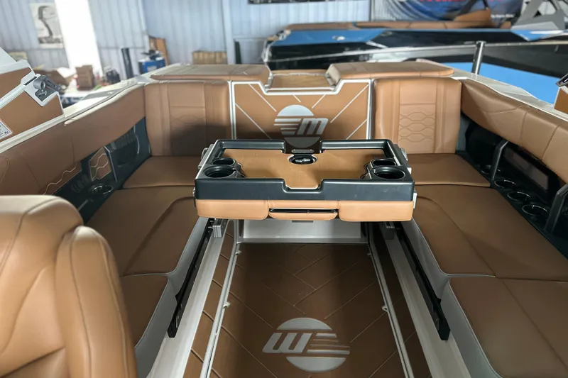 Slide: The Image of 2026 Malibu Wakesetter 23 LSV interior with tan leather seating and cup holders. - 16