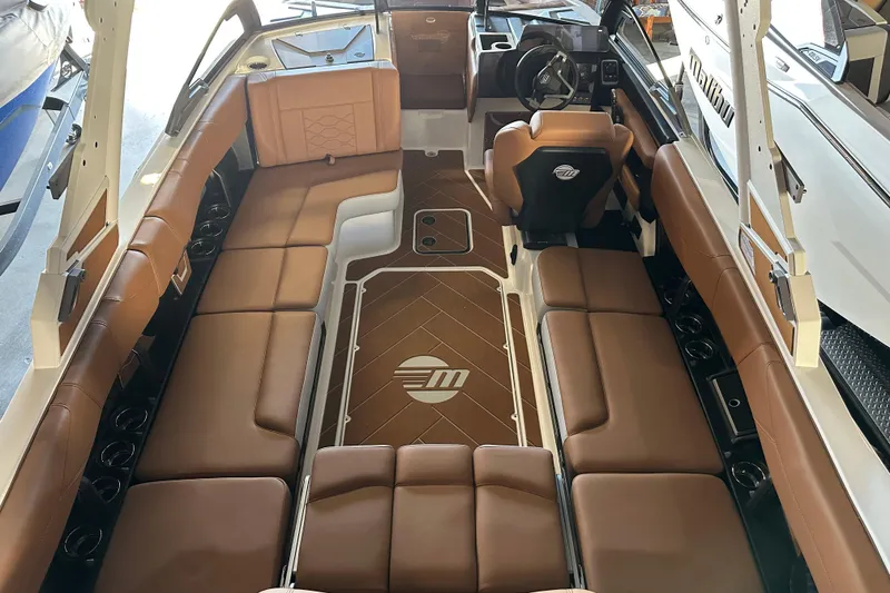 Slide: The Image of 2026 Malibu Wakesetter 23 LSV interior with brown seating and modern dashboard design. - 6