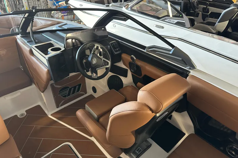 Slide: The Image of 2026 Malibu Wakesetter 23 LSV interior with brown leather seats and modern dashboard. - 7