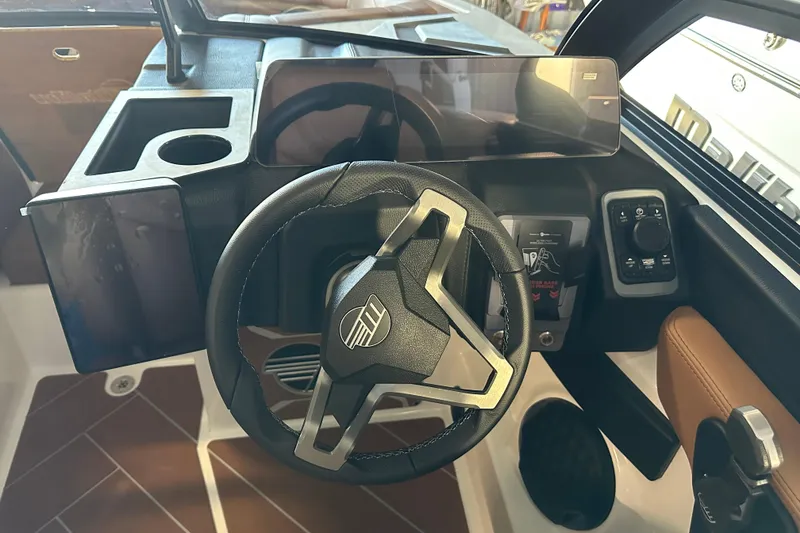 Slide: The Image of 2026 Malibu Wakesetter 23 LSV dashboard with modern steering wheel and digital controls. - 9