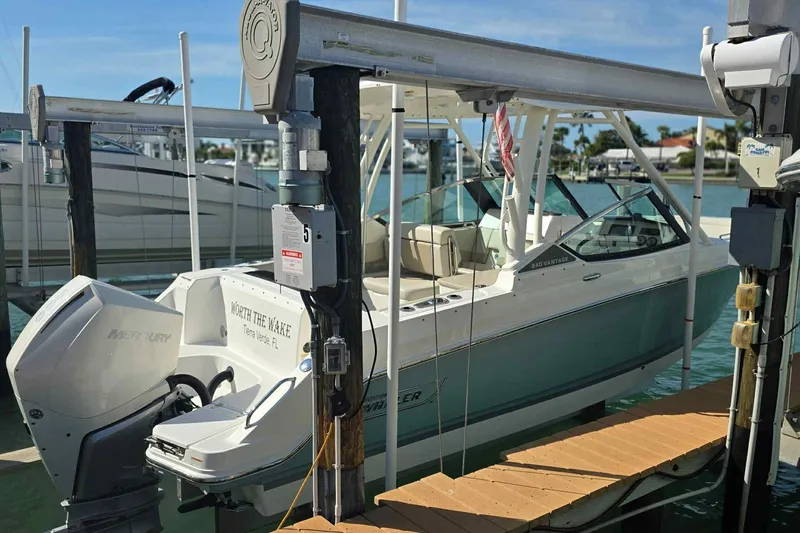 Slide: The Image of 2021 Boston Whaler 240 Vantage boat docked, featuring Mercury engine and sleek design. - 10