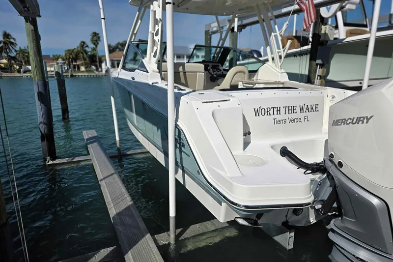 Slide: The Image of 2021 Boston Whaler 240 Vantage boat docked, featuring "Worth the Wake" text, Tierra Verde, FL. - 12