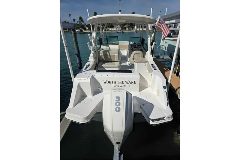 Slide: The Image of 2021 Boston Whaler 240 Vantage boat docked, rear view with American flag. - 14
