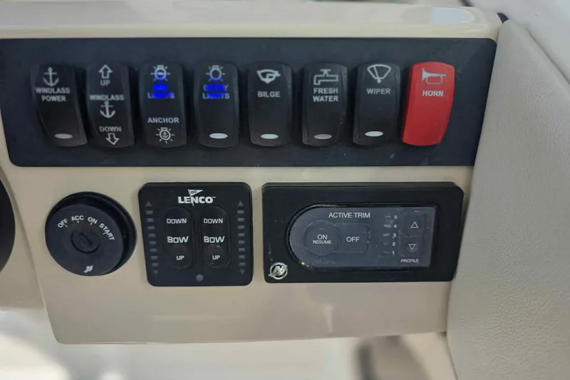 Slide: The Image of Control panel of a 2021 Boston Whaler 240 Vantage boat with various switches and buttons. - 17