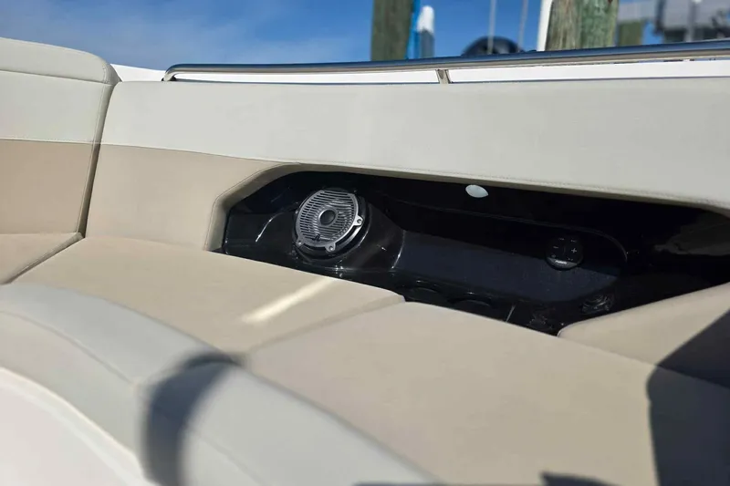 Slide: The Image of Boston Whaler 240 Vantage 2021 boat interior with speaker and beige seating. - 24