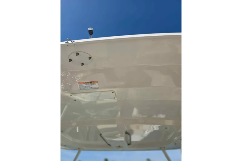 Slide: The Image of 2021 Boston Whaler 240 Vantage boat hull under clear blue sky. - 30