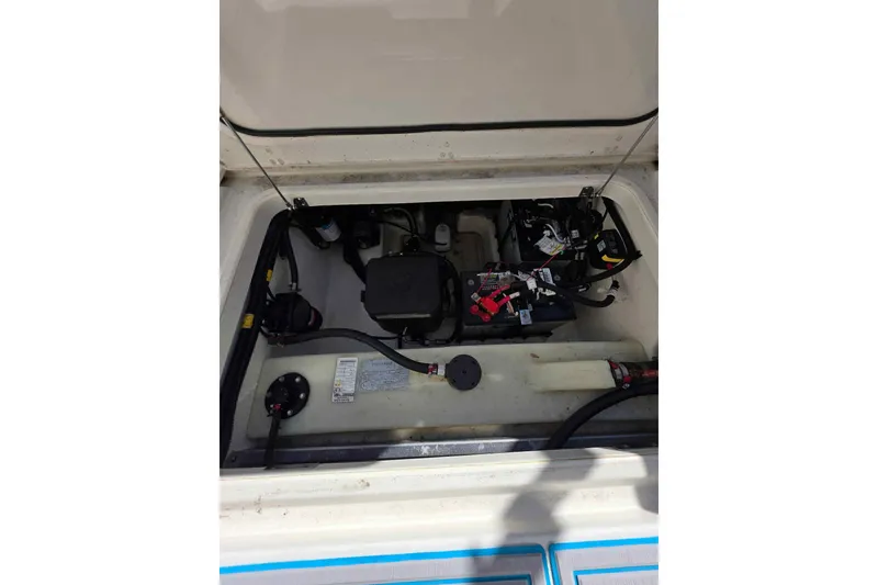 Slide: The Image of 2021 Boston Whaler 240 Vantage engine compartment with visible wiring and components. - 31