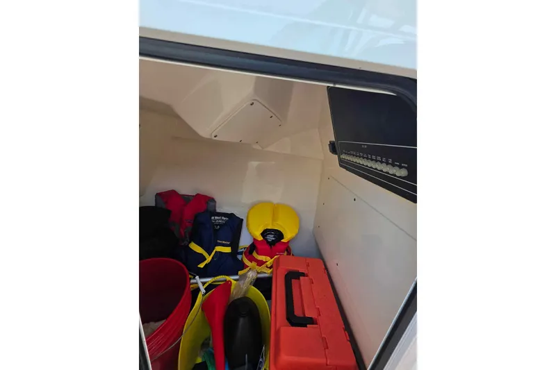 Slide: The Image of Storage compartment of 2021 Boston Whaler 240 Vantage with life jackets and equipment. - 34