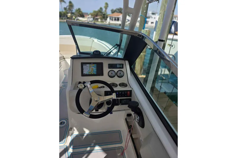 Slide: The Image of 2021 Boston Whaler 240 Vantage boat dashboard with steering wheel and navigation display. - 38