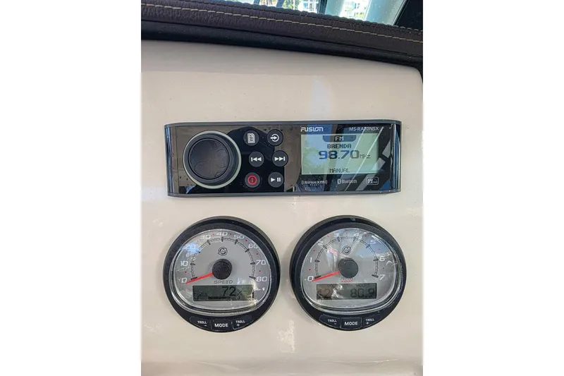 Slide: The Image of 2021 Boston Whaler 240 Vantage dashboard with radio and speed gauges. - 41
