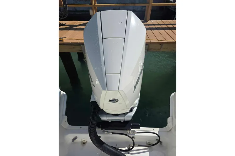 Slide: The Image of Outboard motor on 2021 Boston Whaler 240 Vantage, docked by wooden pier. - 43