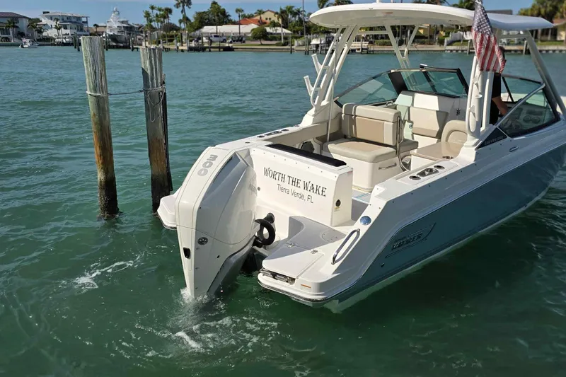 Slide: The Image of 2021 Boston Whaler 240 Vantage boat on water, rear view with American flag. - 5
