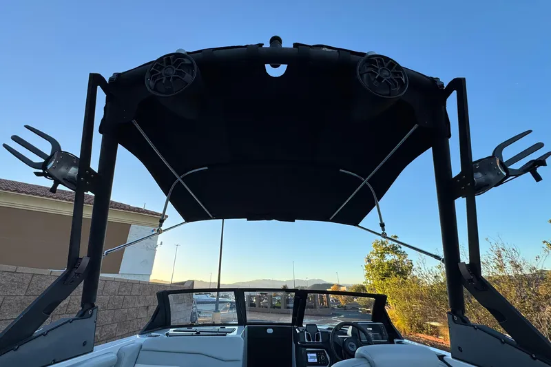 Slide: The Image of 2023 Axis T220 boat with wakeboard tower and speakers under clear blue sky. - 10