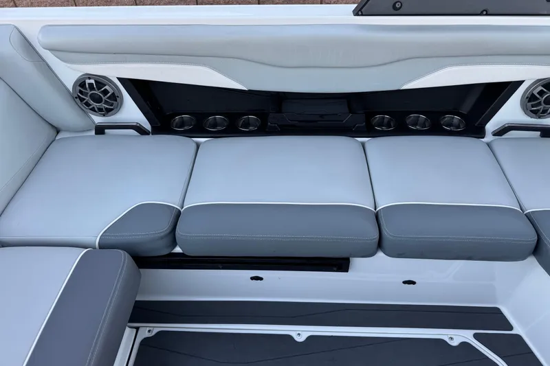 Slide: The Image of 2023 Axis T220 boat interior with gray seating and built-in speakers. - 21