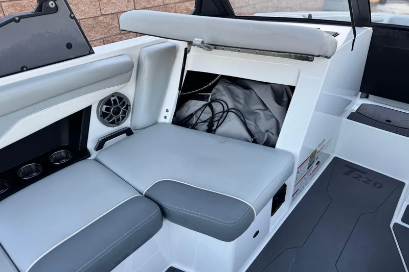 Slide: The Image of 2023 Axis T220 boat interior with storage compartment and speaker system. - 23
