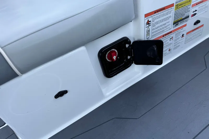 Slide: The Image of 2023 Axis T220 boat panel with safety warnings and a red switch. - 24