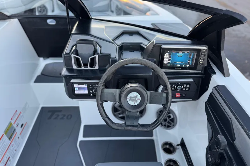Slide: The Image of 2023 Axis T220 boat dashboard with steering wheel and digital display. - 26
