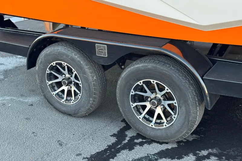 Slide: The Image of 2023 Axis T220 trailer with dual wheels and stylish rims on asphalt. - 33