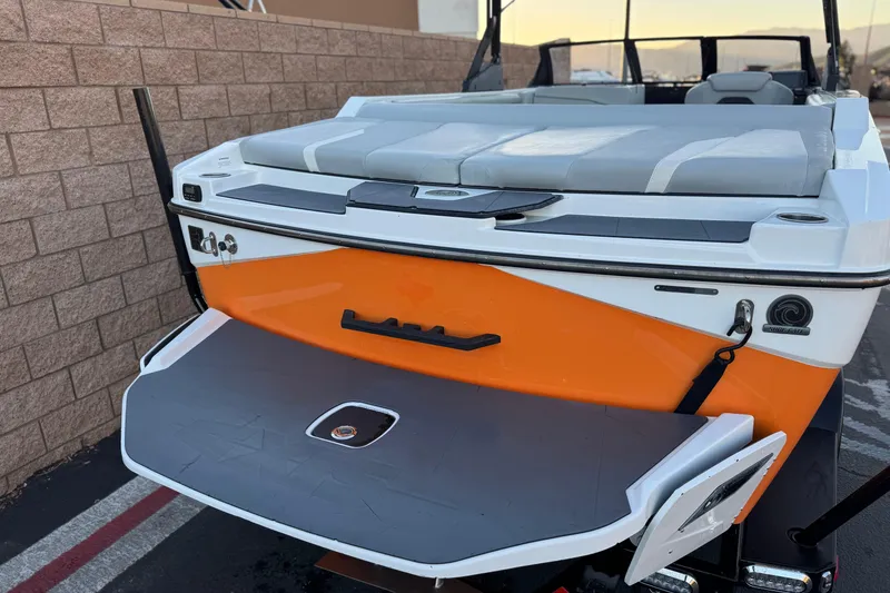 Slide: The Image of 2023 Axis T220 boat rear view with orange and gray detailing. - 6