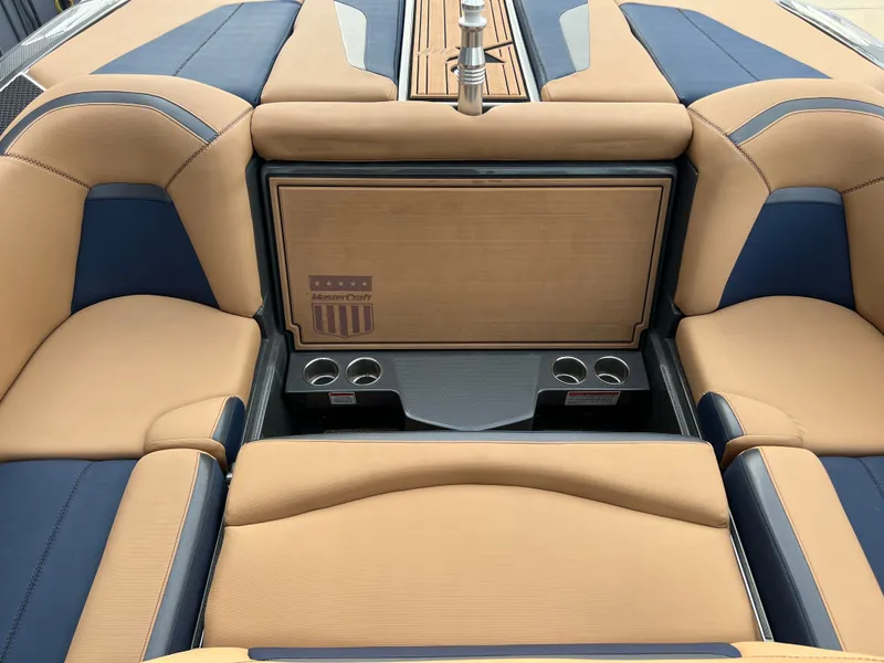 Slide: The Image of Interior of a 2019 MasterCraft XStar boat with beige and blue seating. - 32