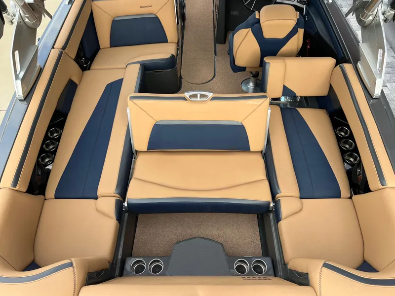 Slide: The Image of Interior of a 2019 MasterCraft XStar with beige and blue seating. - 33