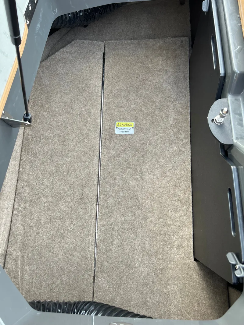 Slide: The Image of Interior of a 2019 MasterCraft XStar boat with carpeted flooring. - 34