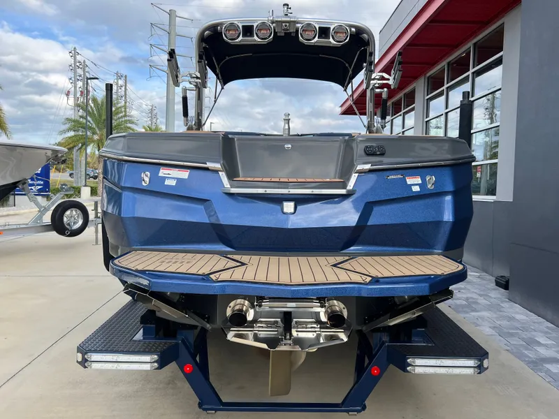 Slide: The Image of Rear view of a blue 2019 MasterCraft XStar boat on a trailer. - 5