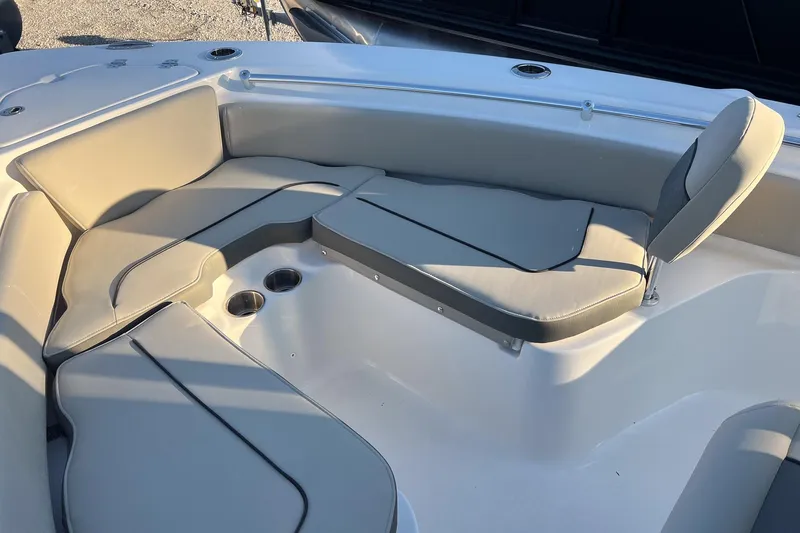 Slide: The Image of 2026 Key West 219 FS boat interior with cushioned seating and cup holders. - 13