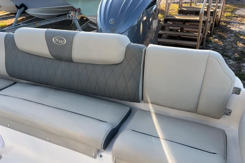 Slide: The Image of 2026 Key West 219 FS boat seat with gray and white upholstery, outdoor setting. - 17