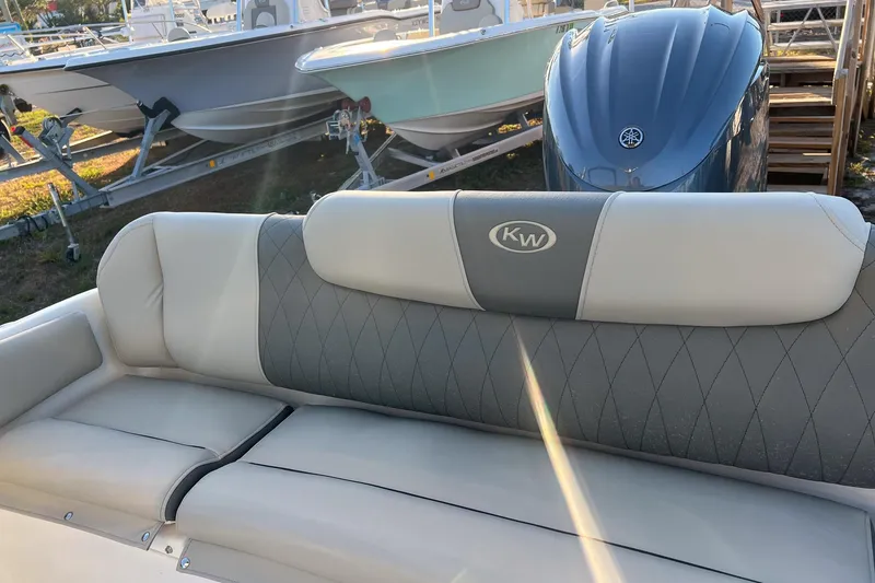 Slide: The Image of 2026 Key West 219 FS boat interior with cushioned seating and KW logo. - 18