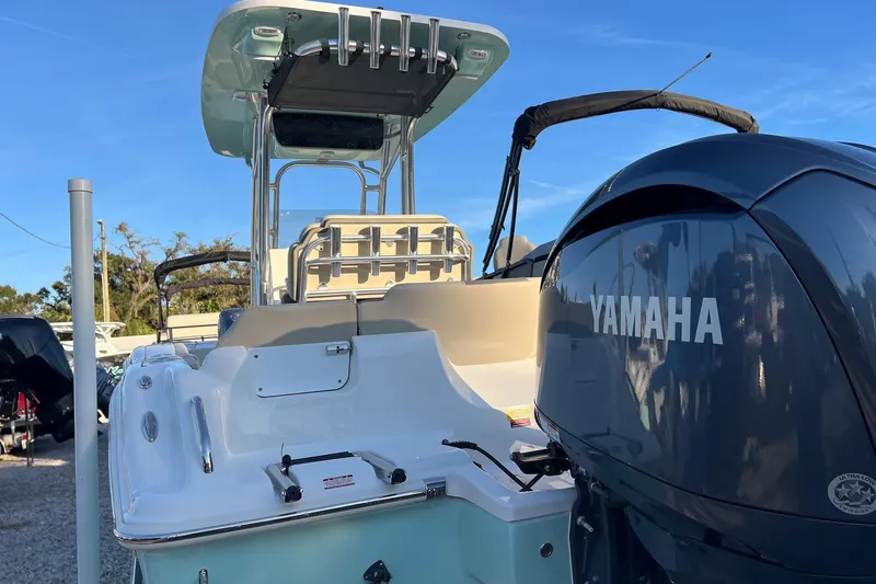 Slide: The Image of 2026 Key West 219 FS boat with Yamaha engine, docked under clear blue sky. - 2