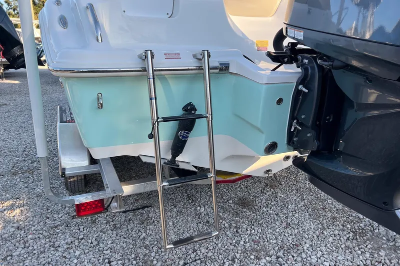 Slide: The Image of 2026 Key West 219 FS boat with ladder and outboard motor on trailer. - 4