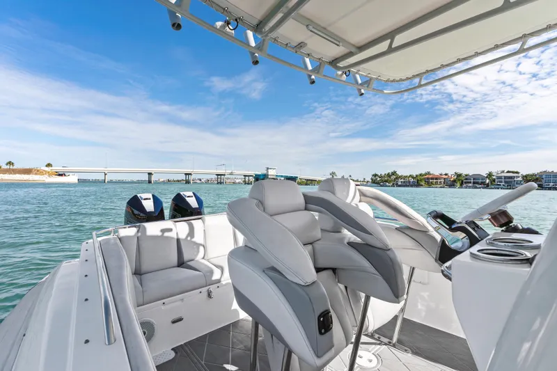 Slide: The Image of Interior view of 2014 Airship 330 boat with modern seating and scenic waterfront backdrop. - 10