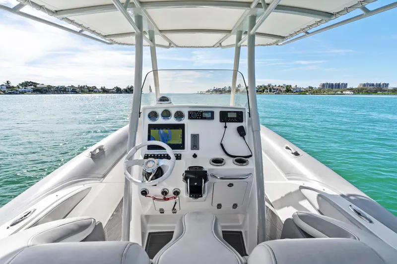 Slide: The Image of Cockpit view of 2014 Airship 330 boat on clear blue water. - 12