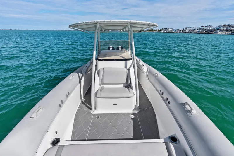 Slide: The Image of 2014 Airship 330 boat on turquoise water with clear sky background. - 9