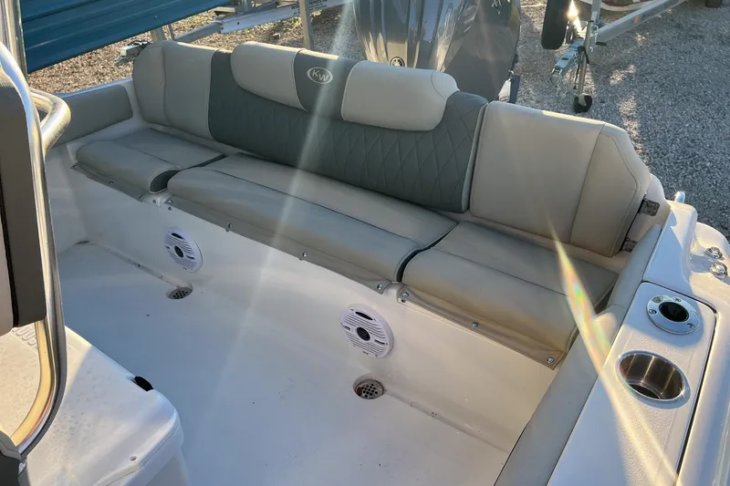 Slide: The Image of 2026 Key West 219 FS boat interior with cushioned seating and built-in speakers. - 10