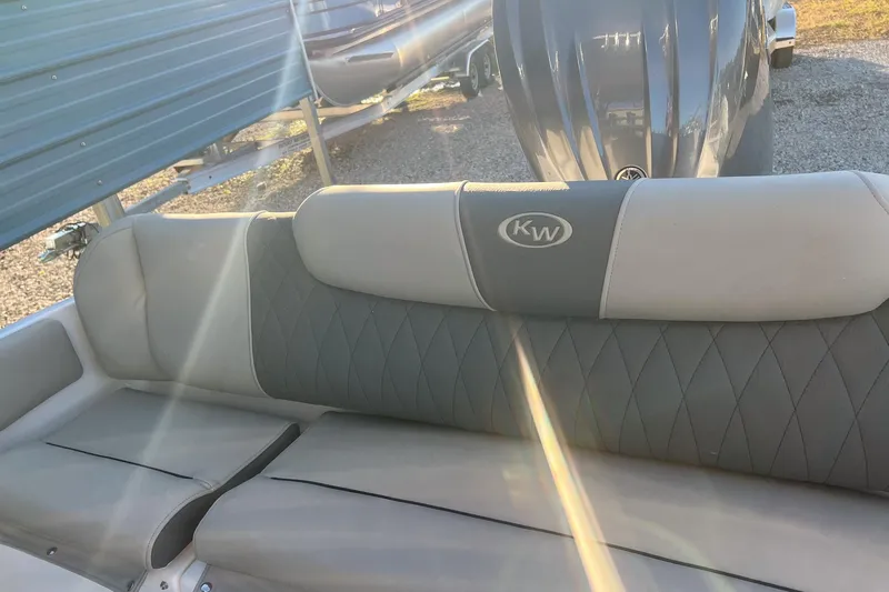 Slide: The Image of 2026 Key West 219 FS boat interior with sunlight on cushioned seating. - 12