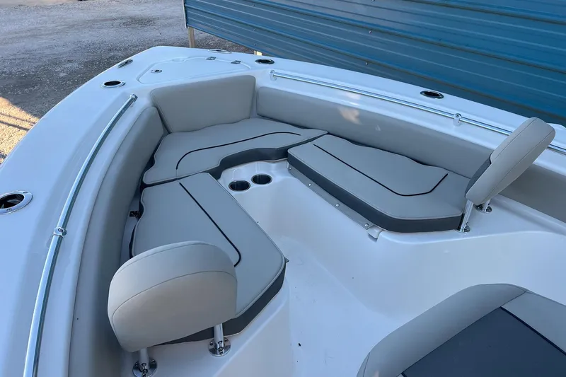 Slide: The Image of 2026 Key West 219 FS boat interior with cushioned seating and cup holders. - 14