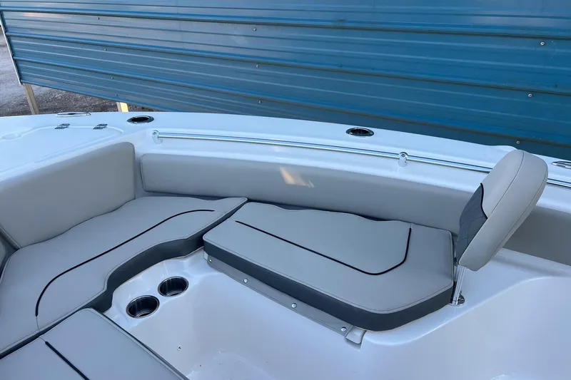 Slide: The Image of 2026 Key West 219 FS boat interior with cushioned seating and cup holders. - 15