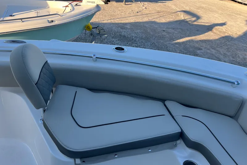 Slide: The Image of 2026 Key West 219 FS boat interior with cushioned seating and sleek design. - 16